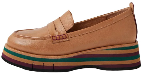A tan leather loafer on a thick, striped platform sole featuring alternating bands of dark green, maroon, and tan.
