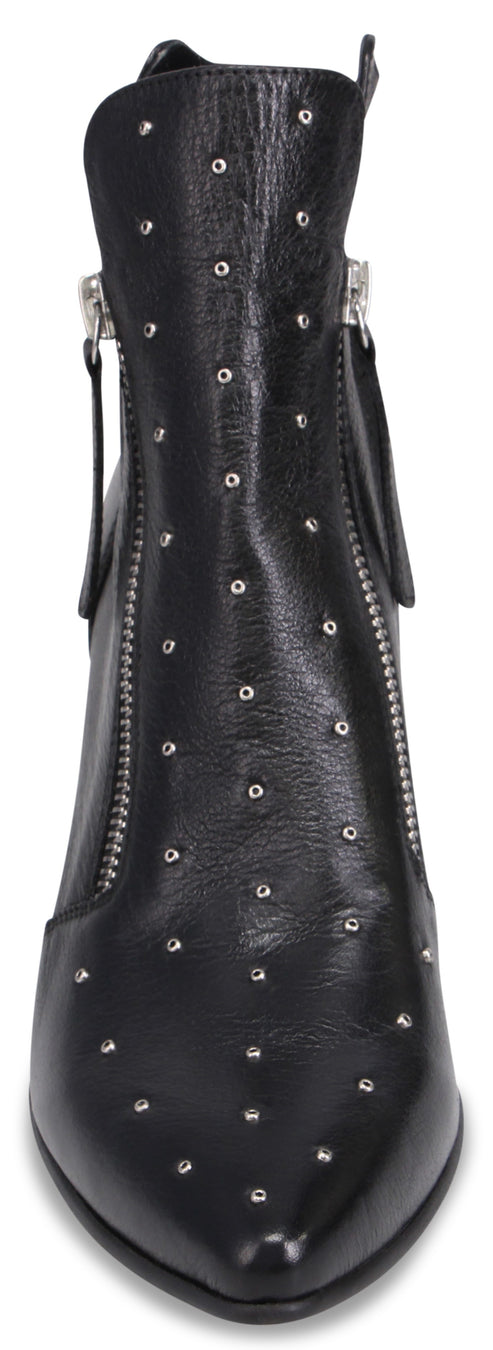 A black leather ankle boot with a pointed toe, adorned with small silver studs across the front, featuring silver zippers running vertically along both sides of the shaft.
