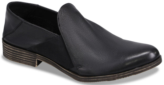 A black leather slip-on shoe with a low, stacked heel and a pointed toe.