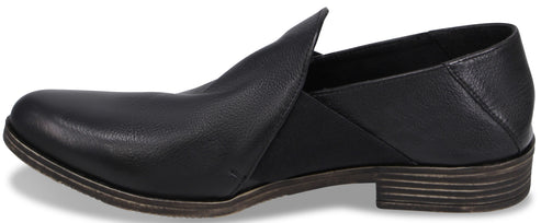 A black leather slip-on shoe with a low stacked heel and a pointed toe, featuring an elastic gore panel on the side.