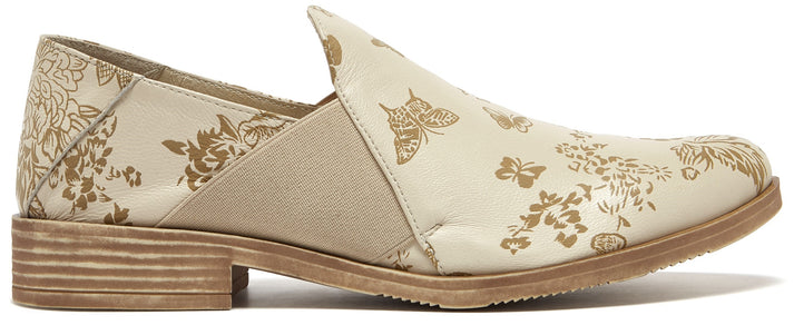 Beige slip-on shoe with floral and butterfly pattern.