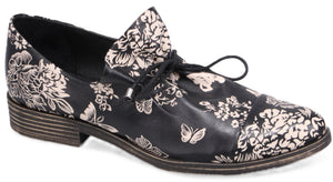 Black floral patterned women's leather shoe with shoelaces.