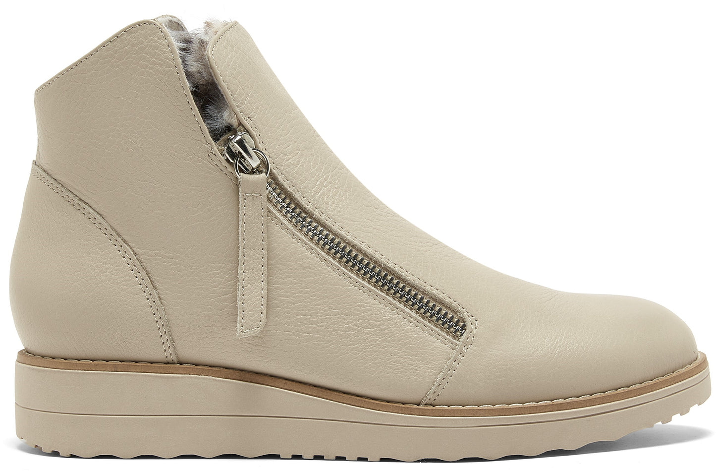 A beige leather ankle boot with a side zipper closure and a soft grey fur lining, set on a chunky, matching beige wedge sole.
