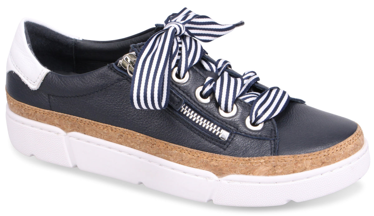 Navy leather sneaker with white and navy striped laces, zipper detail, cork trim, and white sole.