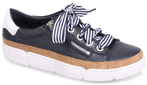 Navy leather sneaker with white and navy striped laces, zipper detail, cork trim, and white sole.