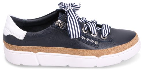 A low top sneaker with navy leather and white ribbon laces.