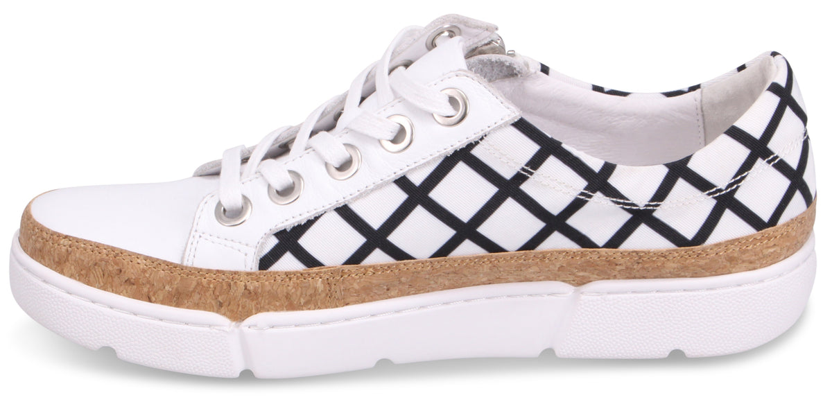White sneaker with black geometric pattern and cork trim.