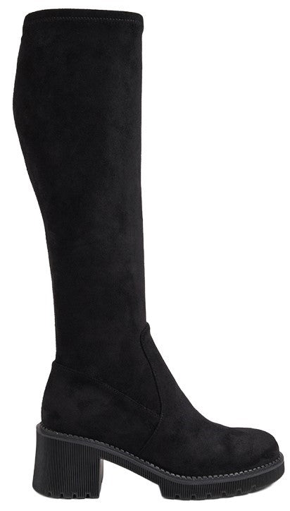 A black suede knee-high pull-on boot with a thick block heel and a lugged sole, shown in profile.