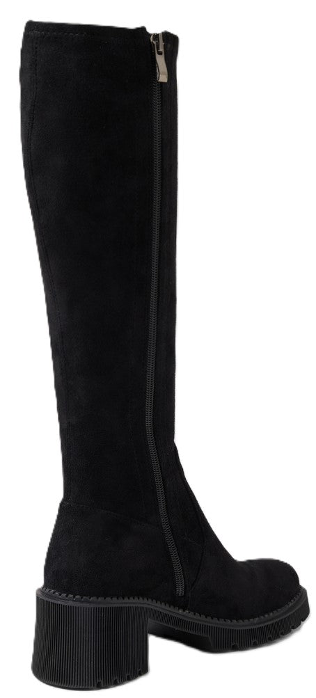 A black suede knee-high boot featuring a block heel, a thick lug sole, and a full-length side zipper.
