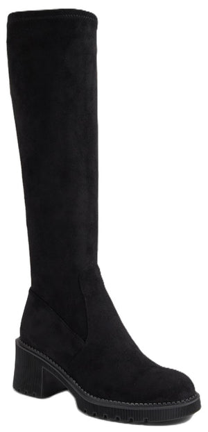 A black suede knee-high boot with a rounded toe, a block heel, and a lug sole with visible stitching around the base.