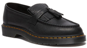 A black leather loafer with a pebbled texture, a kiltie fringe, and a tassel detail on the upper, featuring yellow stitching along the welt and a chunky rubber sole.