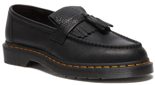 A black leather loafer with a pebbled texture, a kiltie fringe, and a tassel detail on the upper, featuring yellow stitching along the welt and a chunky rubber sole.