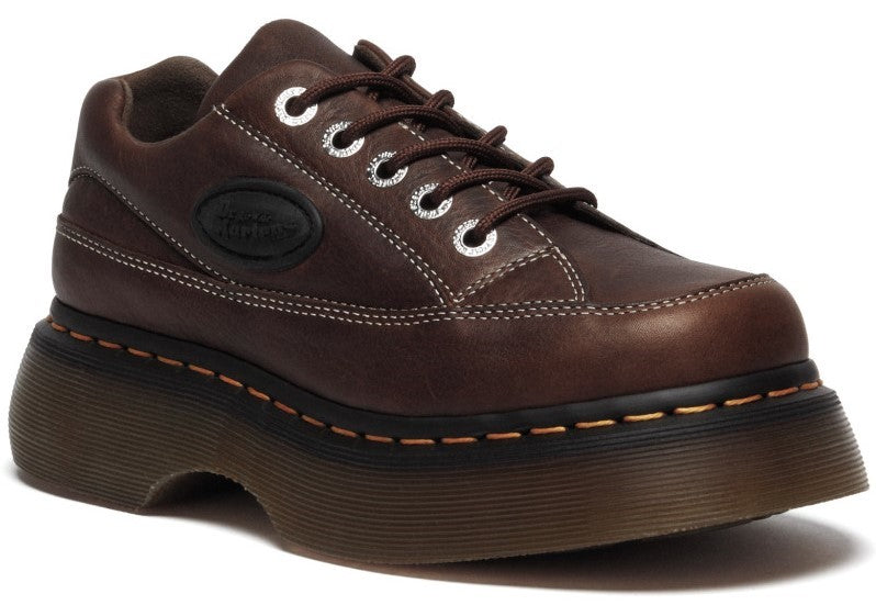 Brown platform leather shoe with white stitching and oval logo.