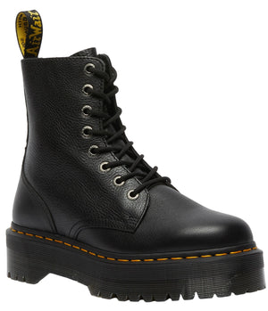 Black platform boot with yellow stitching and a yellow and black pull tab.