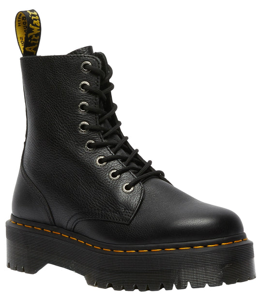 Black platform boot with yellow stitching and a yellow and black pull tab.