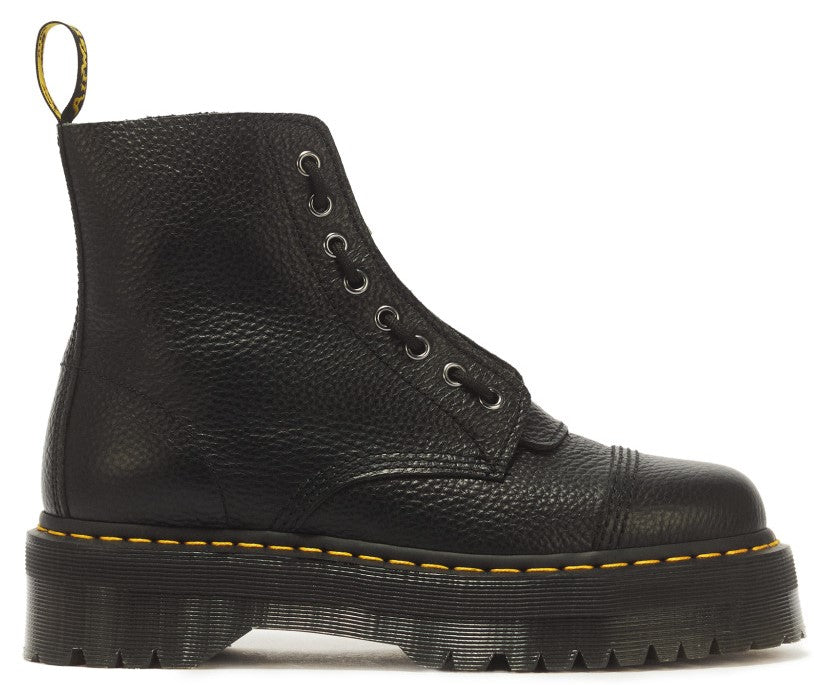 A black leather lace-up platform boot with a textured grain, a reinforced toe cap with double-row stitching, a yellow heel pull tab with black lettering, and a chunky, grooved rubber sole with characteristic yellow welt stitching.