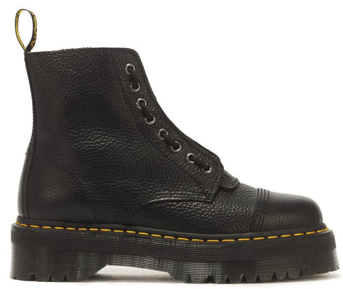 A black leather lace-up platform boot with a textured grain, a reinforced toe cap with double-row stitching, a yellow heel pull tab with black lettering, and a chunky, grooved rubber sole with characteristic yellow welt stitching.