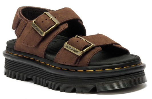 Brown suede sandals with black platform sole and brass buckles.