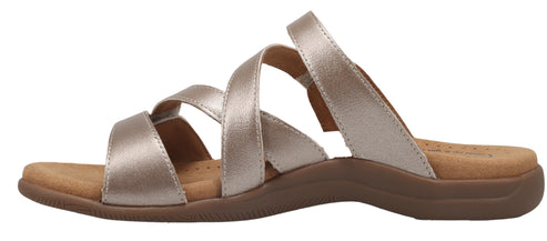 A women's gold sandal with a multi-strap design and a low heel.