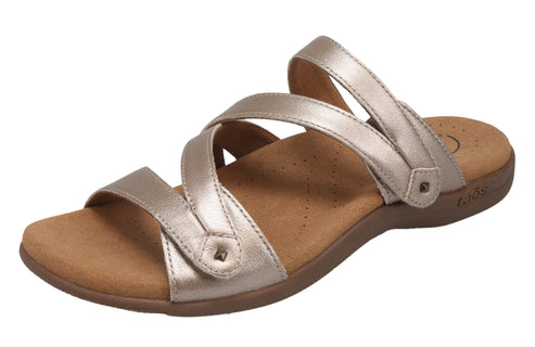 Gold sandal with multiple straps and flat sole.