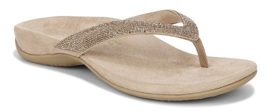 A beige sandal with a beaded strap.