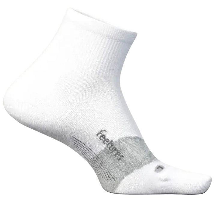 A white quarter-length athletic sock with a gray arch support band labeled 'feetures' and a small gray accent mark on the toe, shown from a side profile view.