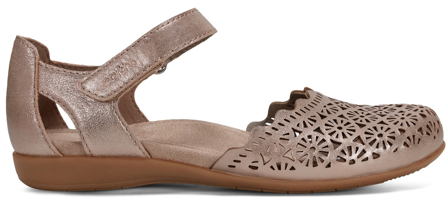 A women's sandal with a hook-and-loop strap, floral cutouts, and a brown sole.