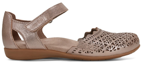 A women's sandal with a hook-and-loop strap, floral cutouts, and a brown sole.