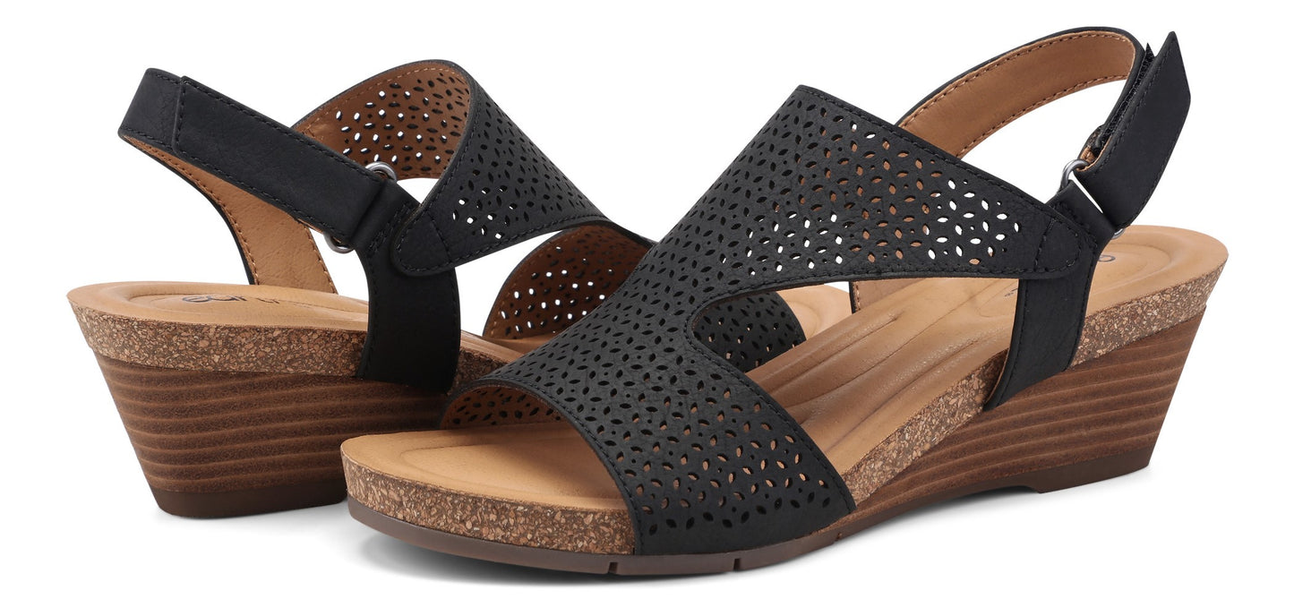 A pair of black wedge sandals with cutout details and adjustable straps.