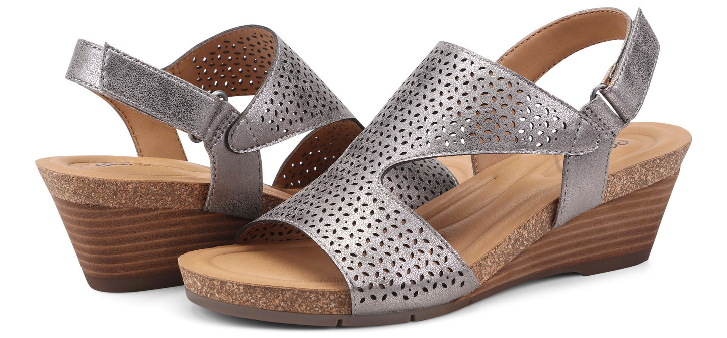A pair of silver wedge sandals with perforated leather.