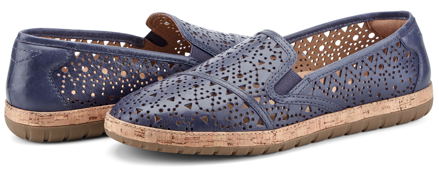 A pair of blue slip-on shoes with cutout designs and cork soles.