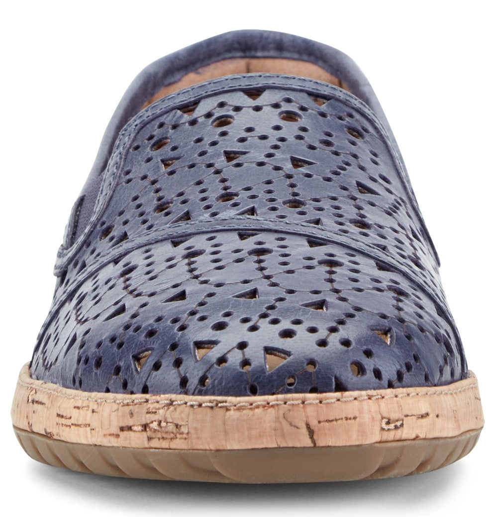 Close-up of a blue perforated leather slip-on shoe with a cork midsole.