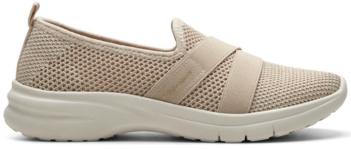 A beige slip-on shoe with a mesh upper and elastic straps.