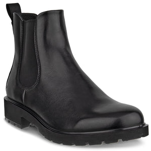 A black leather Chelsea boot with a thick, lugged rubber sole, elastic side panels, and a small pull tab at the heel.