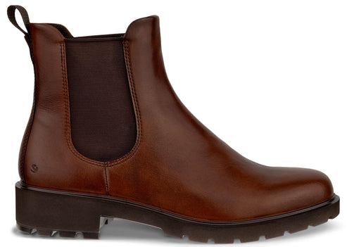 A brown leather Chelsea boot with a pull tab on the back and a dark brown elastic side panel, set on a thick, dark brown treaded sole.