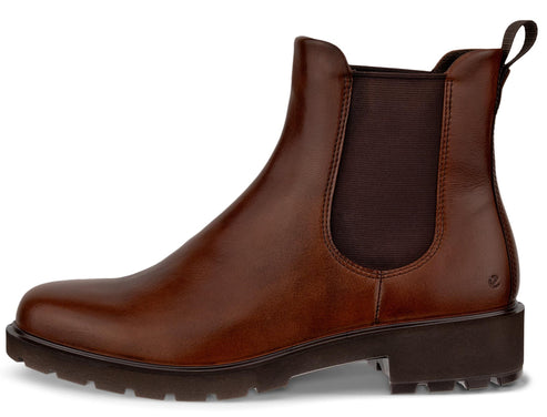 A brown leather Chelsea boot with a round toe, elastic side panel, and a thick, dark brown, lugged rubber sole.