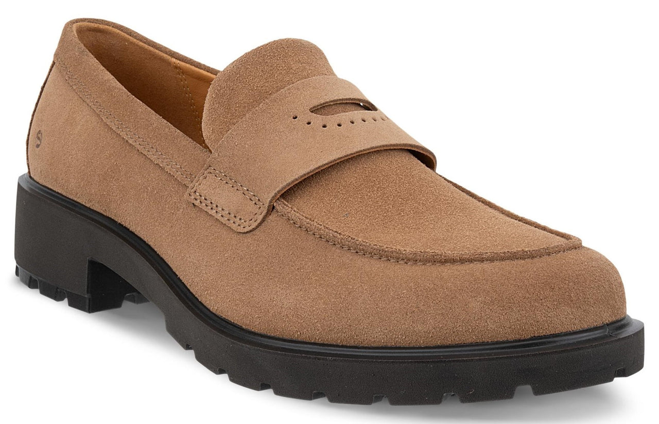 A tan suede loafer with a chunky black lug sole, featuring a strap across the vamp with decorative perforations.