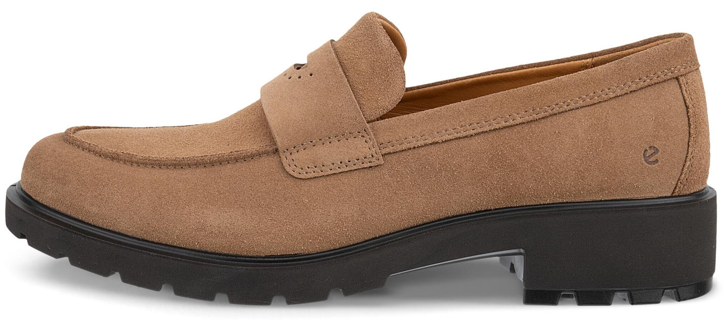A tan suede slip-on loafer with a chunky black lug sole and a small embossed logo near the heel.