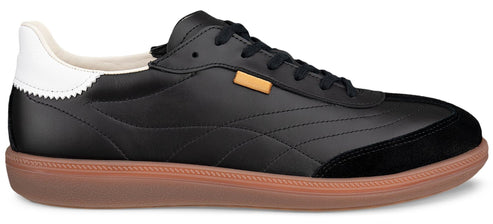 Black sneaker with gum sole and white heel.