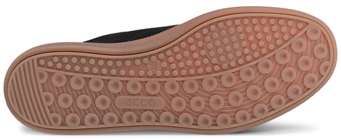 Bottom view of a shoe with a brown sole with circular tread patterns.