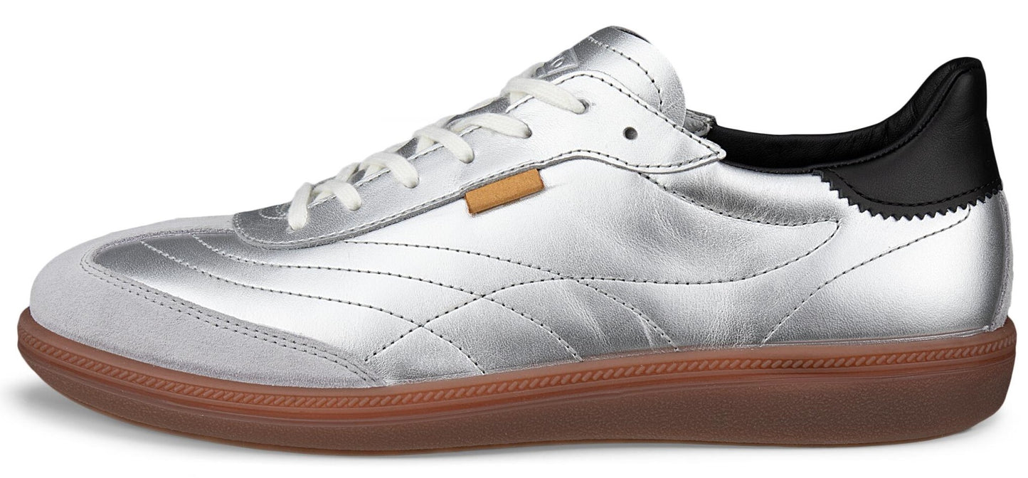 A silver sneaker with white laces and a brown sole.