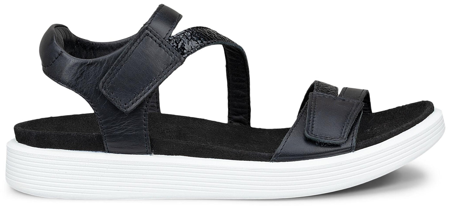 A black sandal with hook and loop fasteners and a white platform sole.