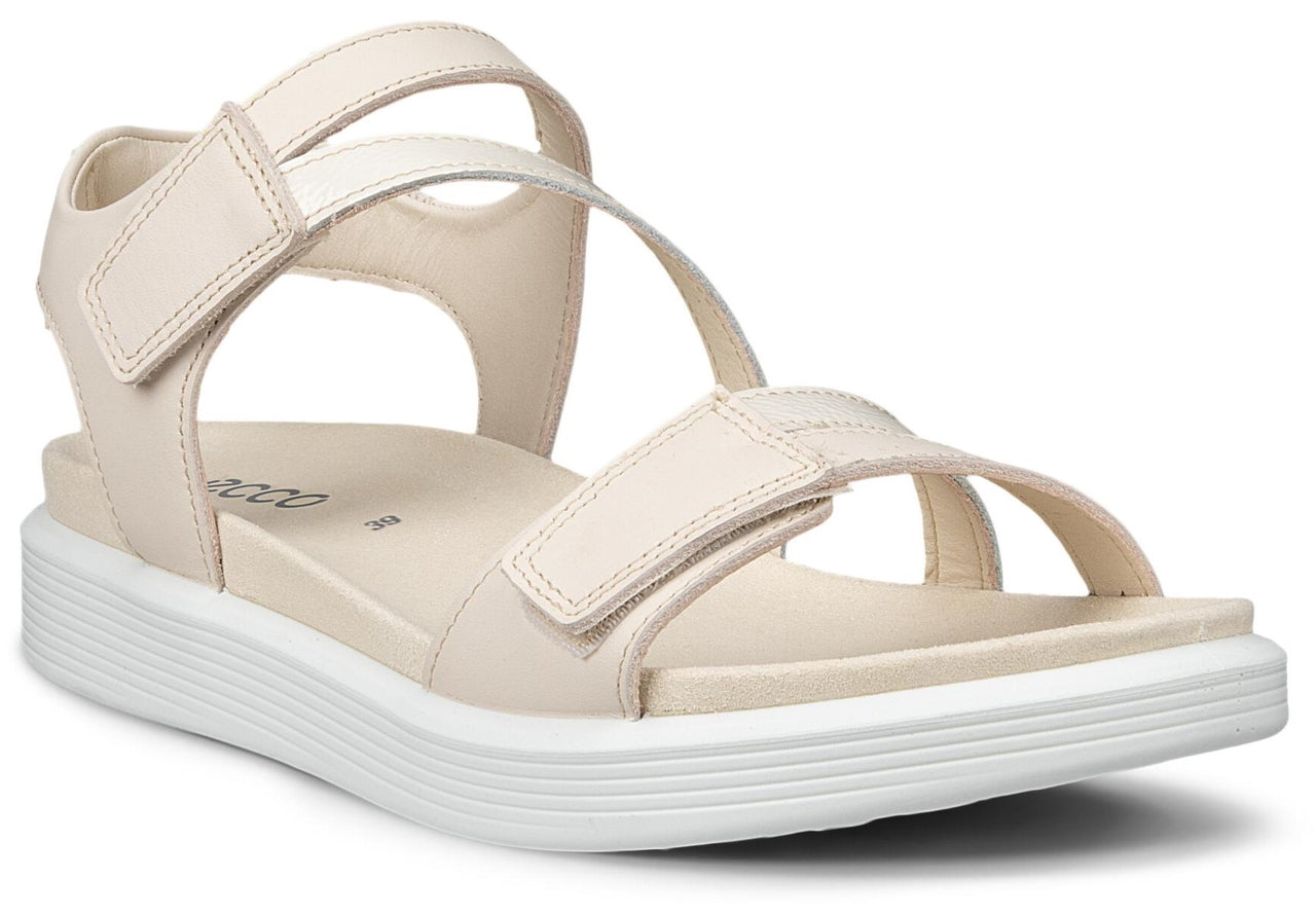 Beige sandal with adjustable velcro straps and a white sole.