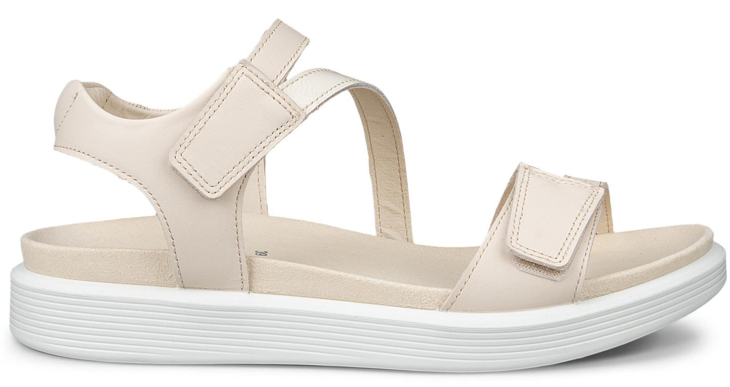 A beige platform sandal with velcro straps.