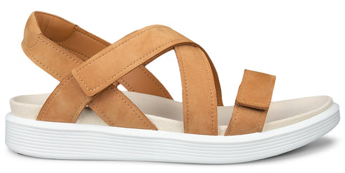 Tan sandal with cross straps and white sole.
