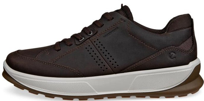 A low top brown shoe with a white sole.
