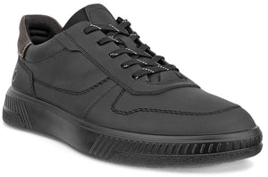 A low-top, matte black leather sneaker with matching black laces featuring thin reflective stripes, a thick black textured rubber sole, and a dark brown padded heel collar.