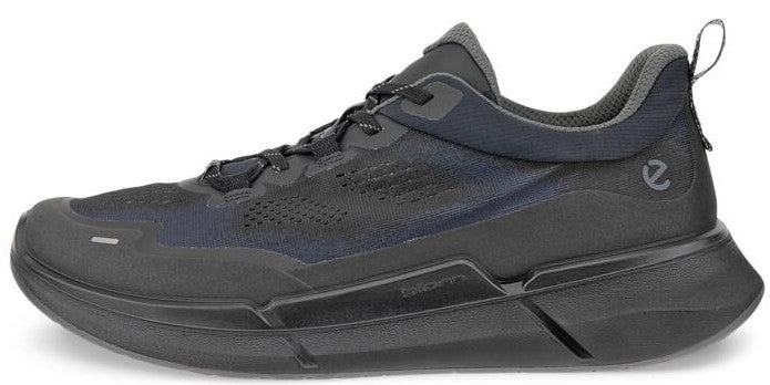 A low-top athletic shoe featuring a thick black sole, a black upper with breathable mesh, and a padded collar.