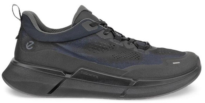 A dark gray sneaker with a thick sole and a pull tab on the back.