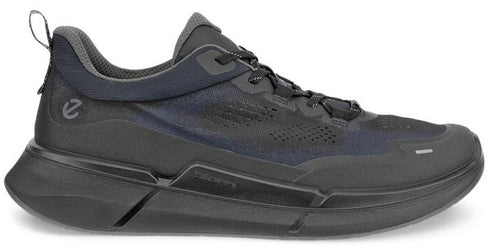 A dark gray sneaker with a thick sole and a pull tab on the back.